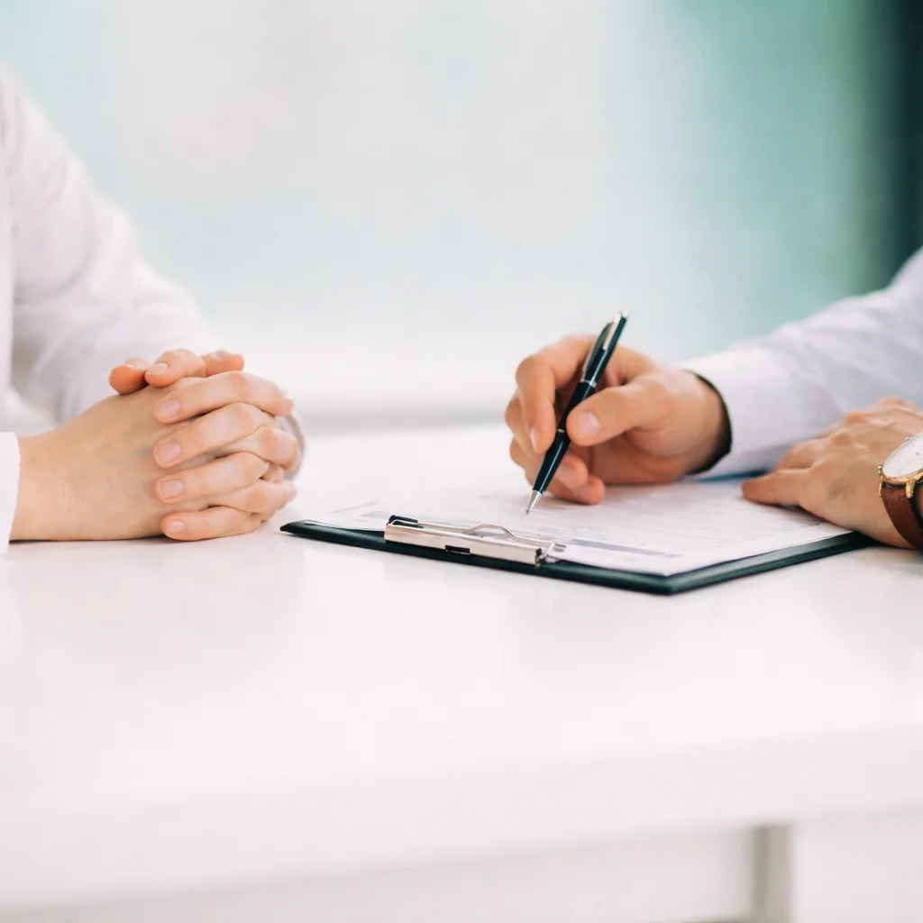 Care provider offering support by holding a patient's hands